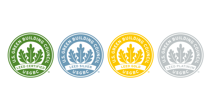 LEED certification levels by the U.S. Green Building Council: green for Certified, blue for Silver, yellow for Gold, and grey for Platinum, each with a leaf emblem.